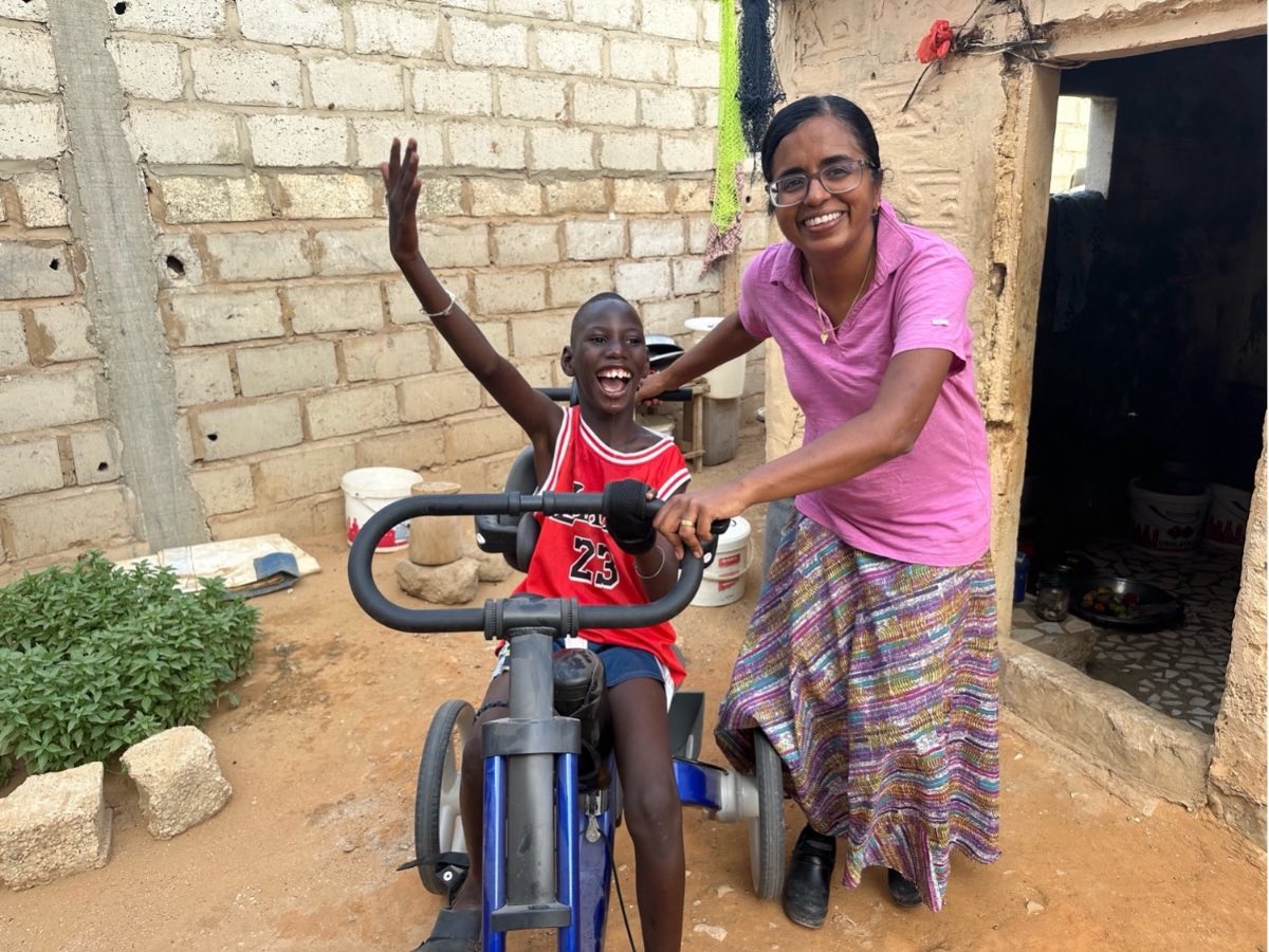 Suja Brane with a boy trying out a new adaptive trike