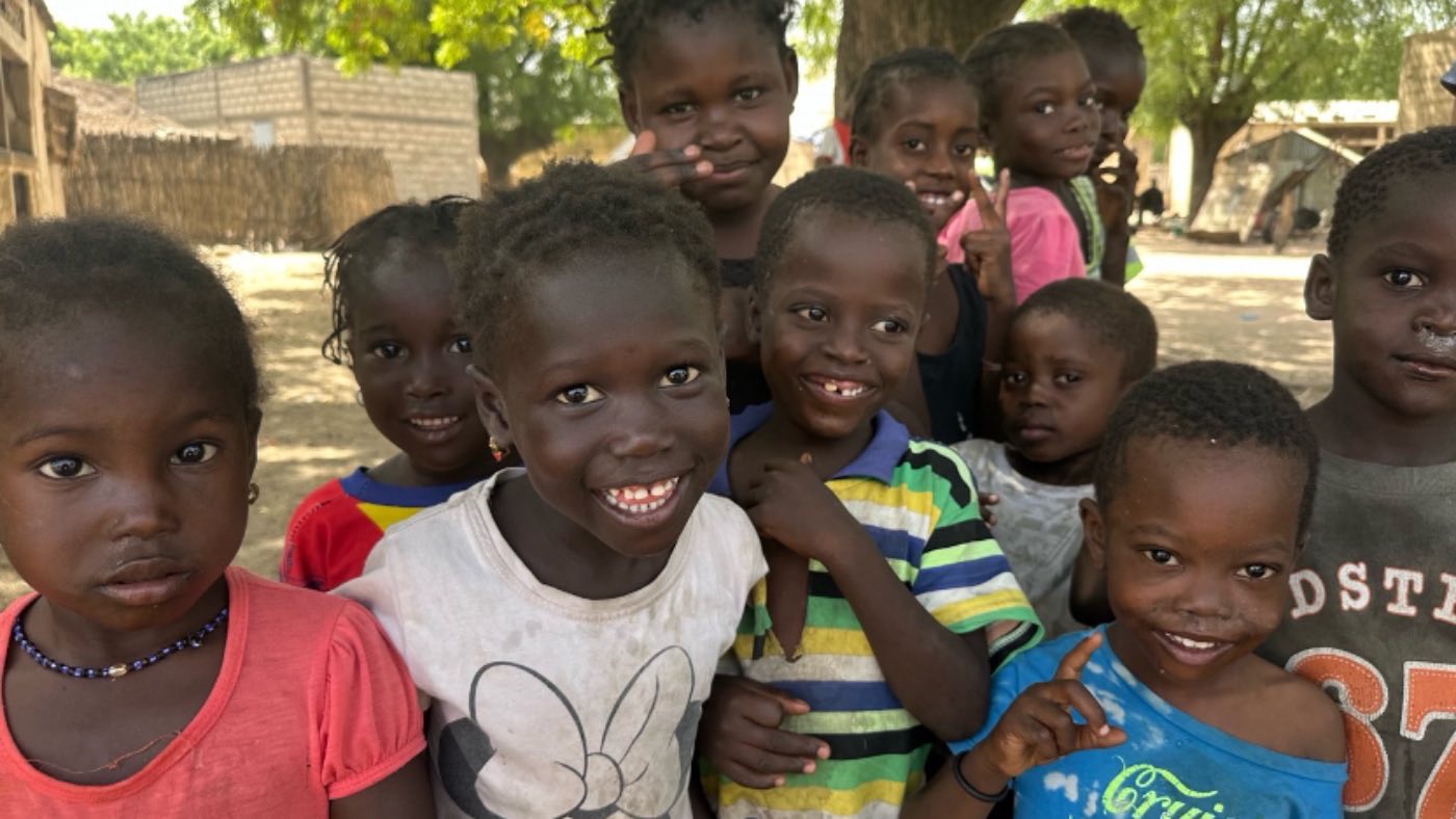A group of smiling children in a Senegalese village
