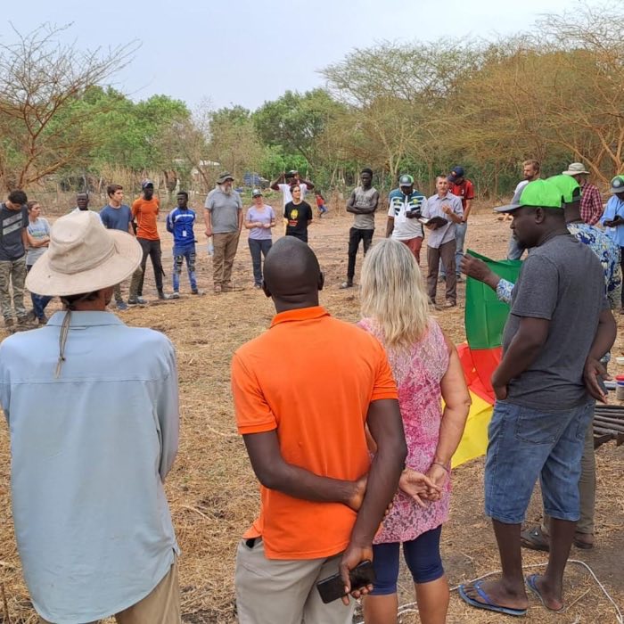 Trainees gathered in a field during the West Africa regional training