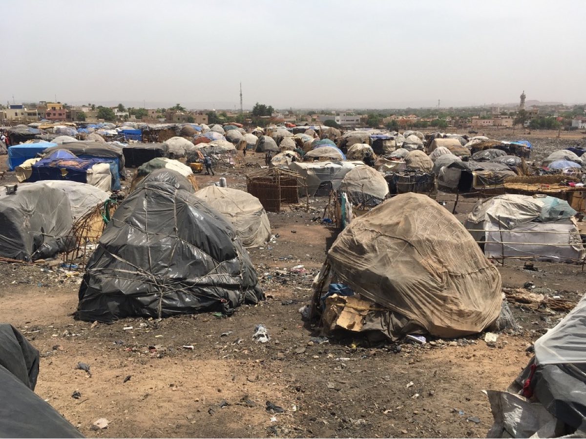 Tarpaulin shelters stretching across a displacement camp